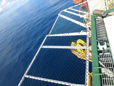 Green vinyl-coated chain link helideck netting.