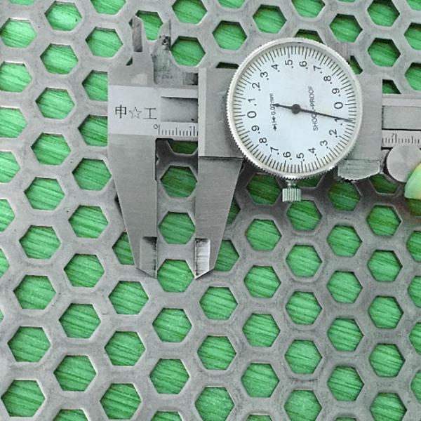 A caliper is used to test the opening diameter of the perforated metal